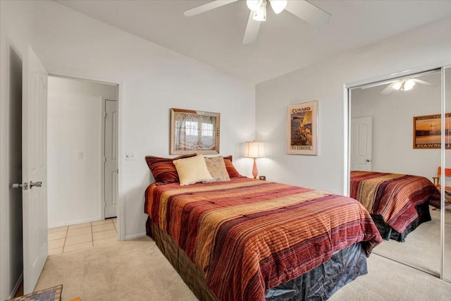 bedroom featuring ceiling fan, light carpet, and a closet