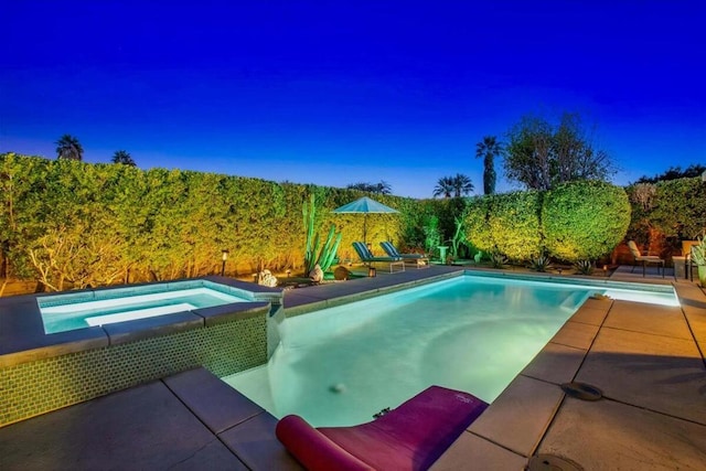 view of pool with an in ground hot tub and a patio area