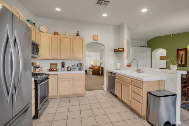 kitchen with light brown cabinetry, sink, tile countertops, and stainless steel appliances