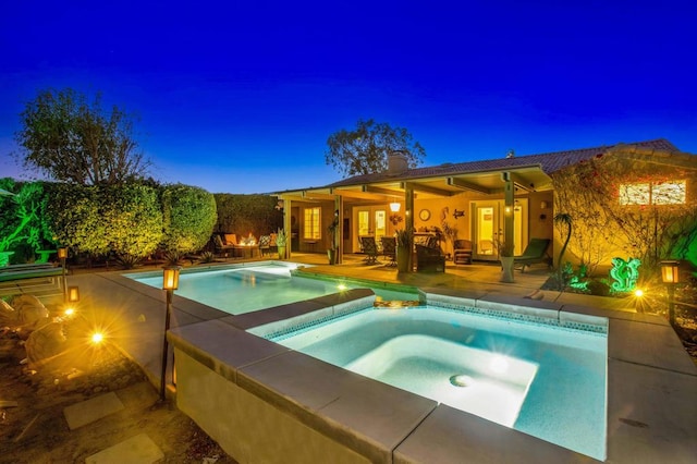 view of pool featuring an in ground hot tub and a patio