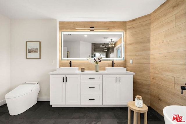 bathroom with vanity and wood walls