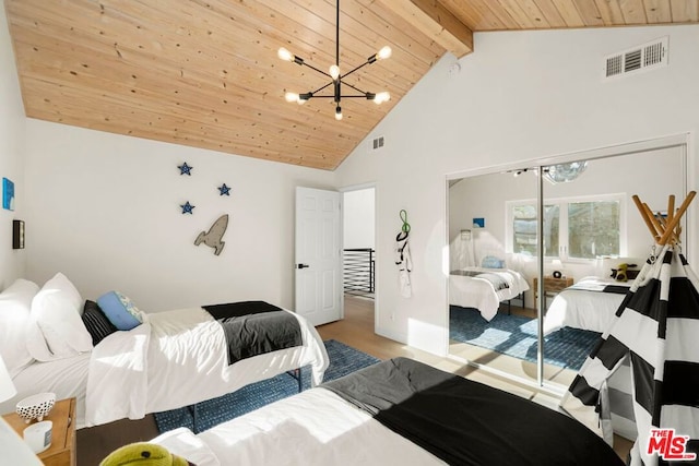 bedroom featuring beamed ceiling, wooden ceiling, a closet, and a notable chandelier