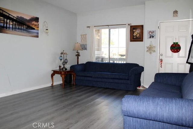 living room with dark hardwood / wood-style flooring