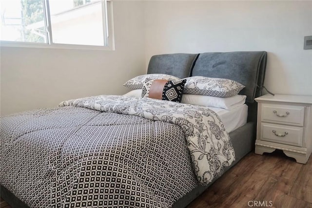 bedroom with dark hardwood / wood-style floors