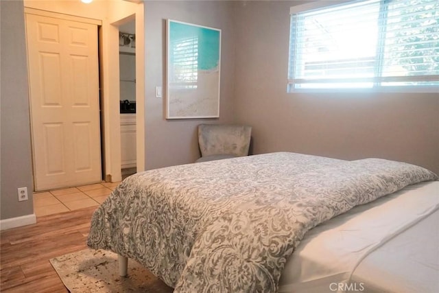 bedroom with wood-type flooring and a closet