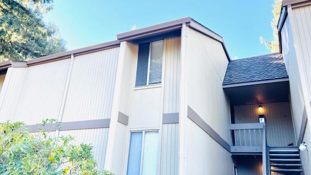 view of side of home with a balcony