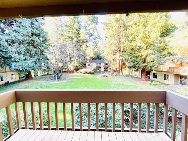 wooden deck featuring a yard