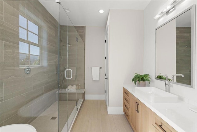 bathroom featuring an enclosed shower and vanity