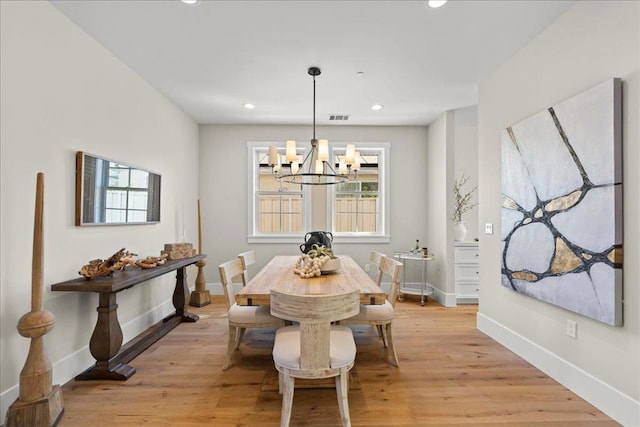 dining space featuring a chandelier and light hardwood / wood-style floors