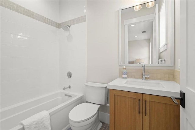 full bathroom featuring toilet, tiled shower / bath combo, and vanity