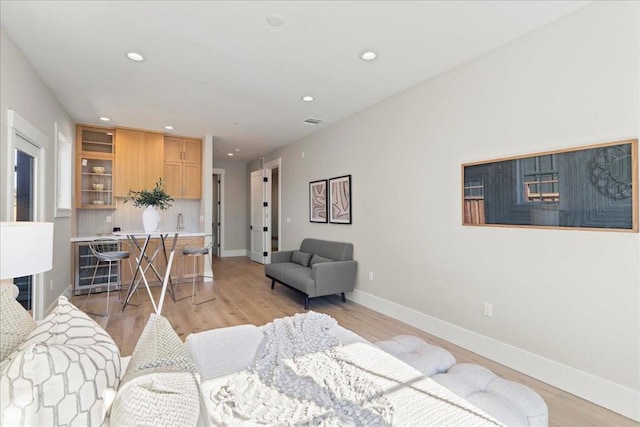 living room featuring light wood-type flooring and beverage cooler