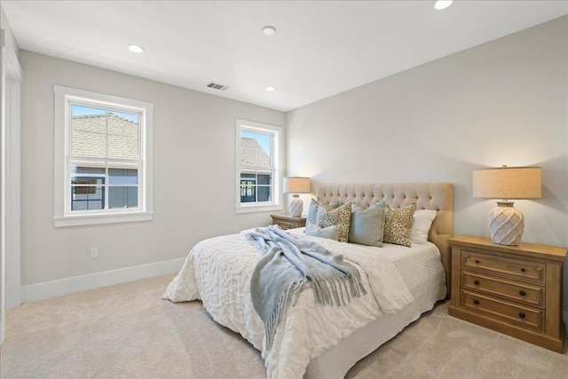 carpeted bedroom featuring multiple windows