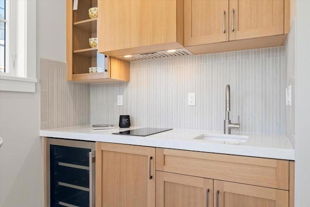 kitchen featuring sink, black electric stovetop, backsplash, and wine cooler