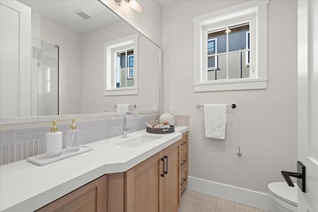 bathroom featuring toilet, vanity, and tile patterned floors