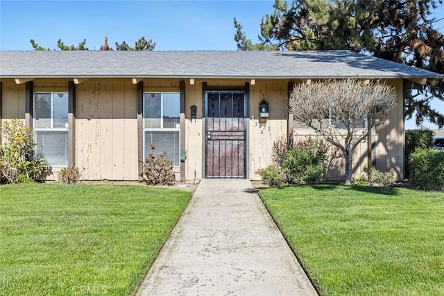 doorway to property with a lawn