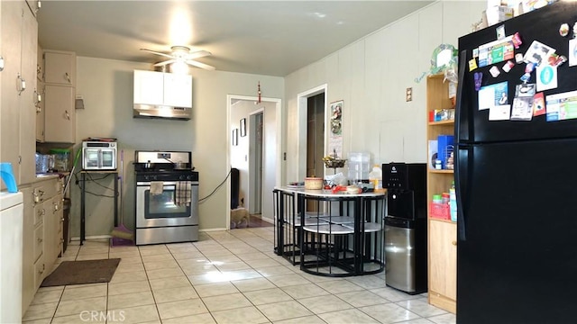 kitchen with ceiling fan, black refrigerator, electric range, and light tile patterned flooring