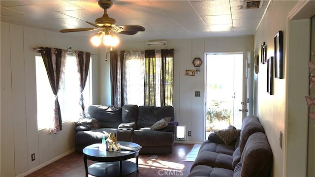 living room featuring ceiling fan and parquet flooring