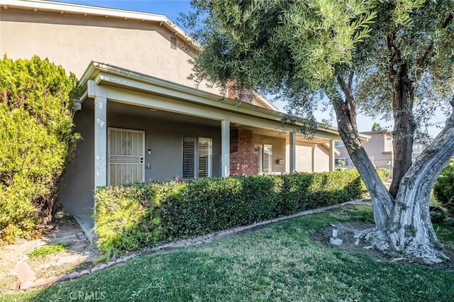 property entrance with a lawn