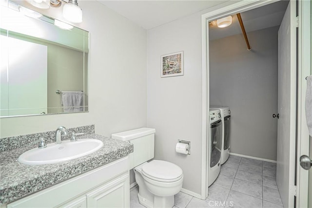 bathroom featuring toilet, tile patterned flooring, separate washer and dryer, and vanity