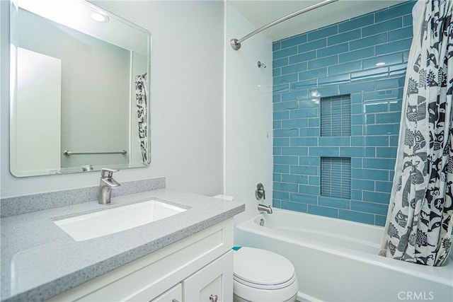 full bathroom featuring toilet, shower / tub combo, and vanity