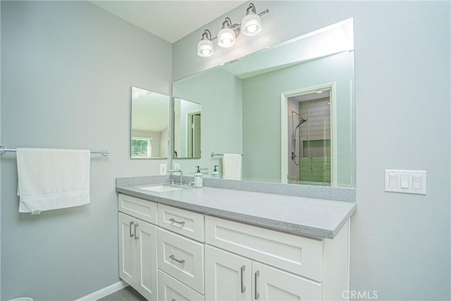 bathroom featuring a shower and vanity