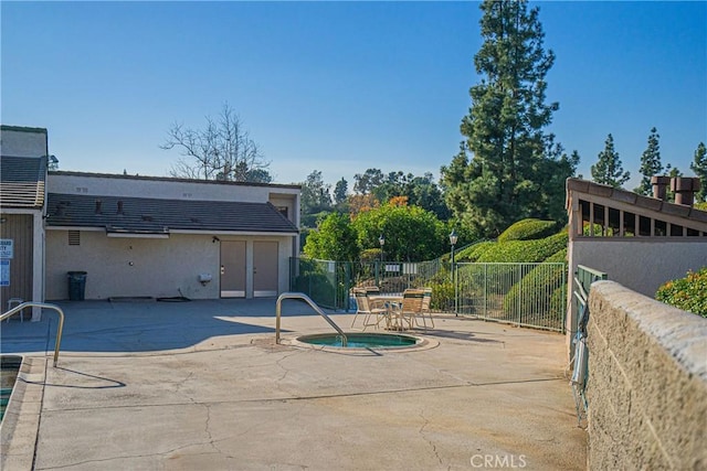 view of pool with a community hot tub and a patio