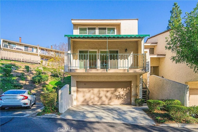 view of front of house with a balcony and a garage