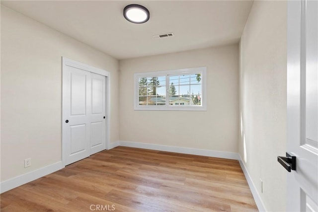 spare room with light hardwood / wood-style flooring