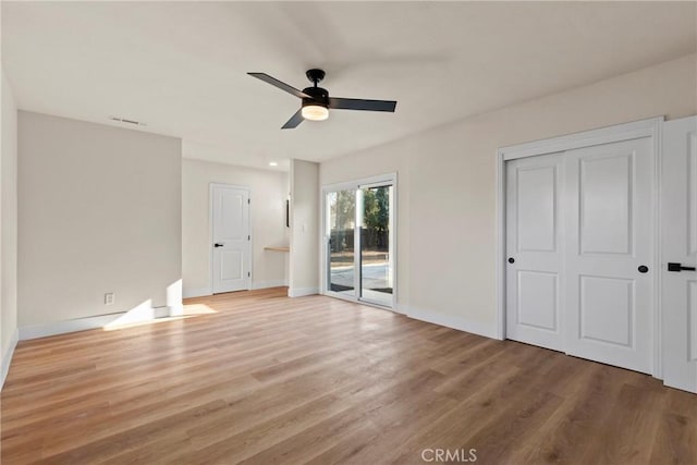 unfurnished bedroom featuring ceiling fan, access to exterior, and light hardwood / wood-style flooring