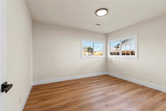 unfurnished room with hardwood / wood-style flooring