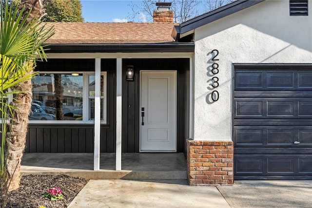 view of exterior entry featuring a garage