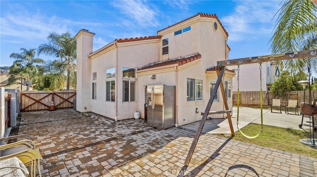 back of house with a patio