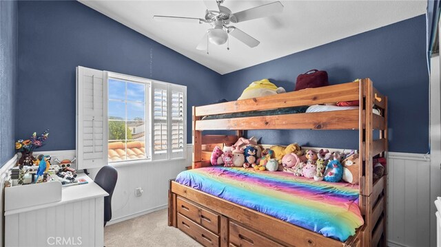 carpeted bedroom featuring lofted ceiling and ceiling fan