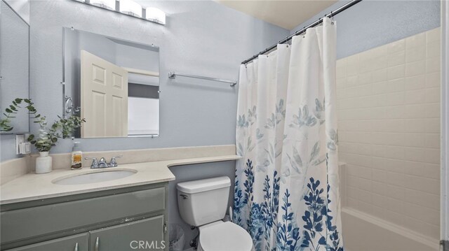 full bathroom featuring shower / bathtub combination with curtain, vanity, and toilet