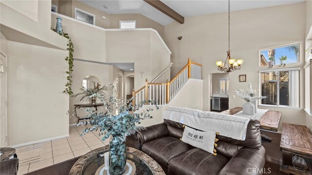 tiled living room featuring a high ceiling, a chandelier, and beamed ceiling