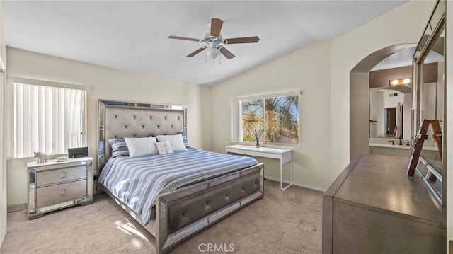 bedroom featuring vaulted ceiling, light colored carpet, and ceiling fan