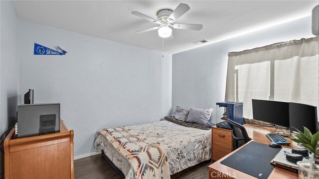 bedroom with ceiling fan and dark hardwood / wood-style floors