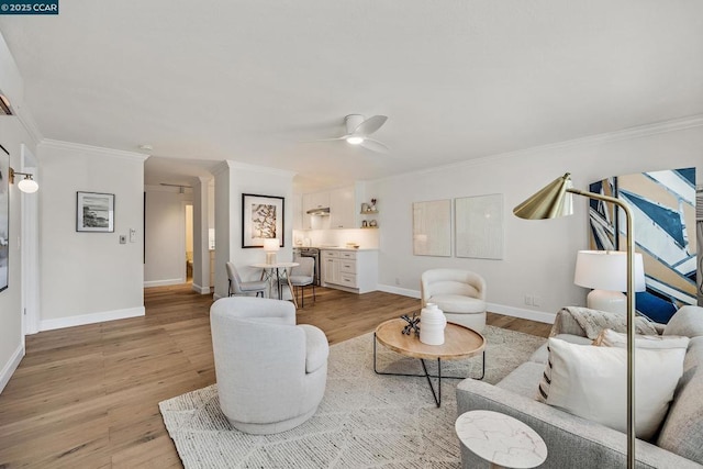 living room with ceiling fan, light hardwood / wood-style flooring, and crown molding