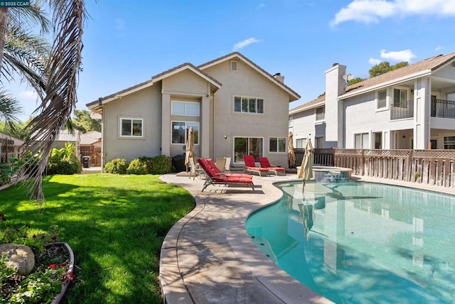 rear view of house with a patio, a fenced in pool, and a lawn