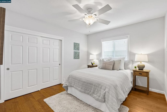 bedroom featuring ceiling fan, a closet, and hardwood / wood-style floors