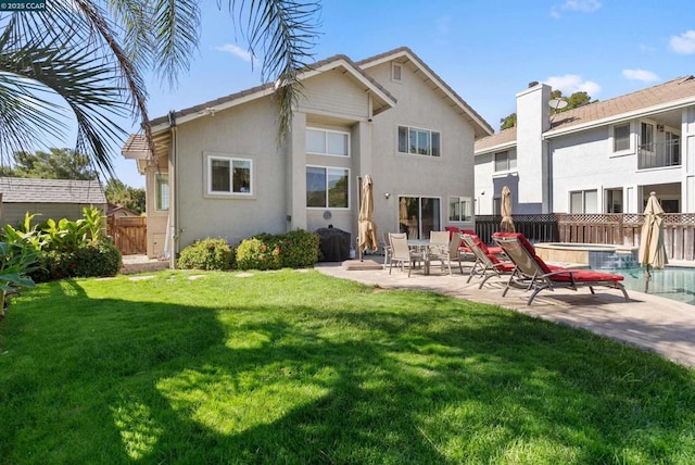 rear view of house with a yard and a patio area