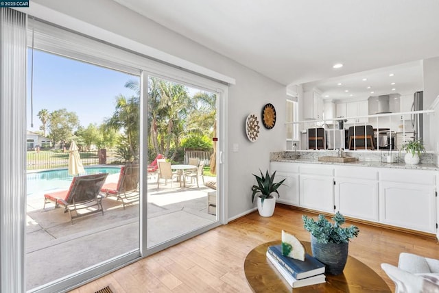 living room with light hardwood / wood-style flooring and sink