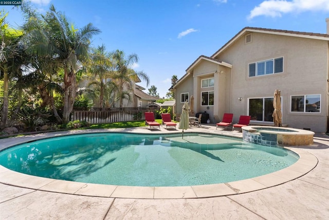 view of swimming pool with a patio area and an in ground hot tub