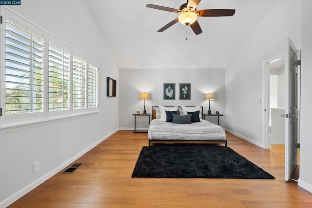 bedroom with vaulted ceiling, ceiling fan, and light hardwood / wood-style floors