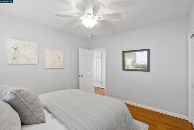 bedroom with ceiling fan and wood-type flooring