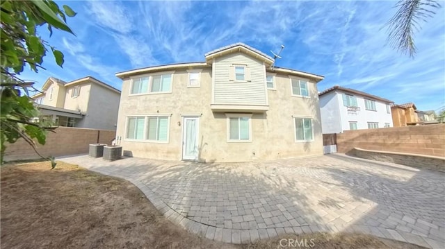 rear view of house with cooling unit and a patio area