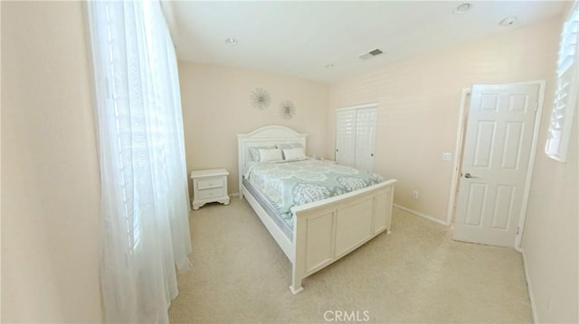 bedroom featuring a closet and light carpet