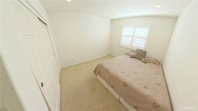 carpeted bedroom with a closet