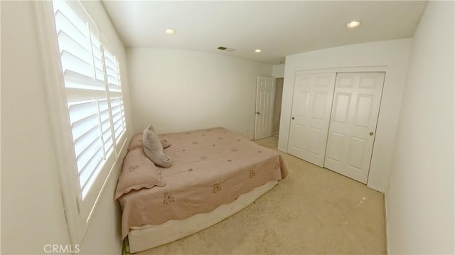 carpeted bedroom with a closet