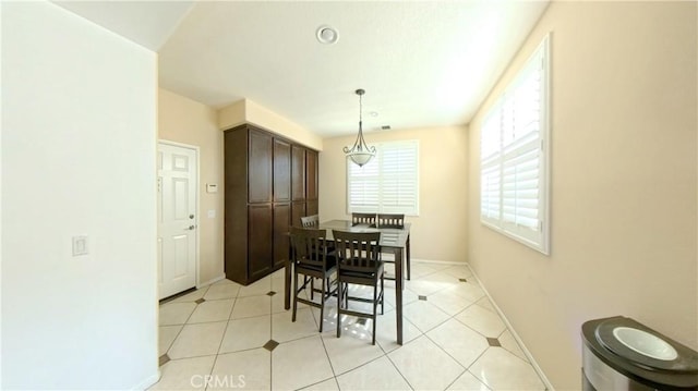 dining area featuring light tile patterned flooring